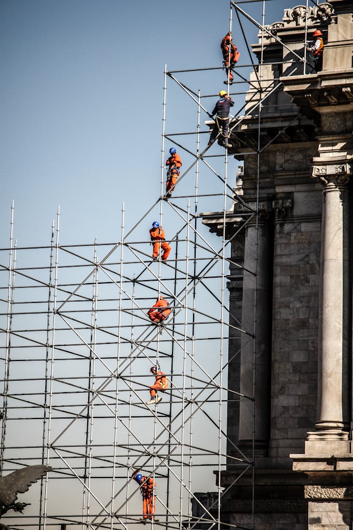 services-03 Workers on scaffolding near historic building in Mexico City. Urban construction setting.